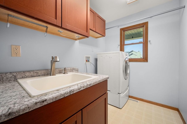 laundry room with light floors, cabinet space, a sink, washer / dryer, and baseboards