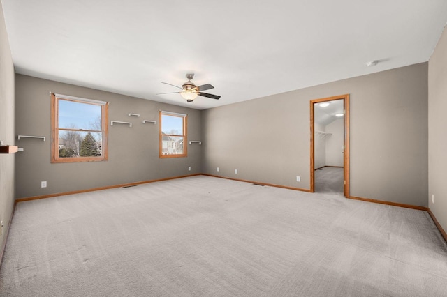 unfurnished room featuring ceiling fan, carpet flooring, and baseboards