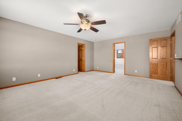 unfurnished room featuring visible vents, a ceiling fan, light colored carpet, and baseboards