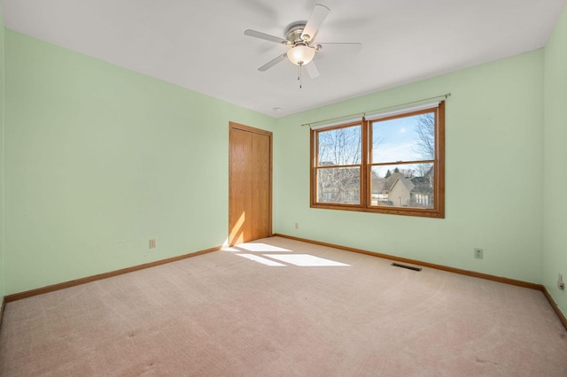 empty room with light carpet, baseboards, and visible vents