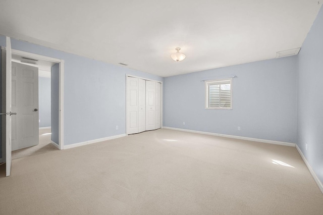 unfurnished bedroom featuring baseboards, a closet, and carpet flooring