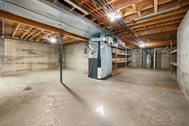 unfinished below grade area featuring gas water heater and heating unit