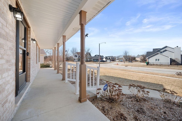 view of patio featuring a porch and a residential view