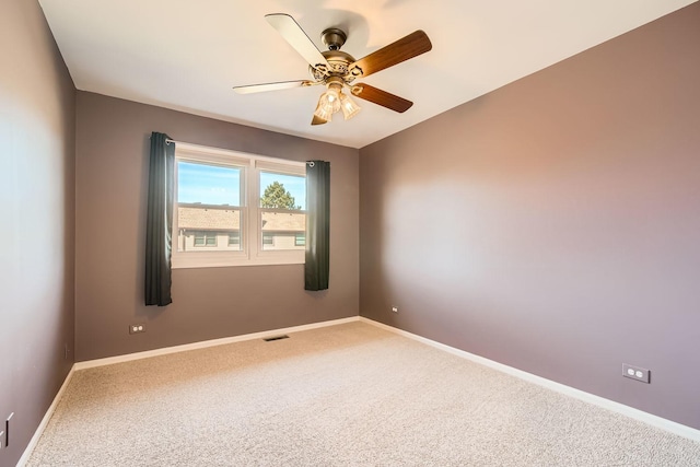 unfurnished room with ceiling fan and carpet flooring