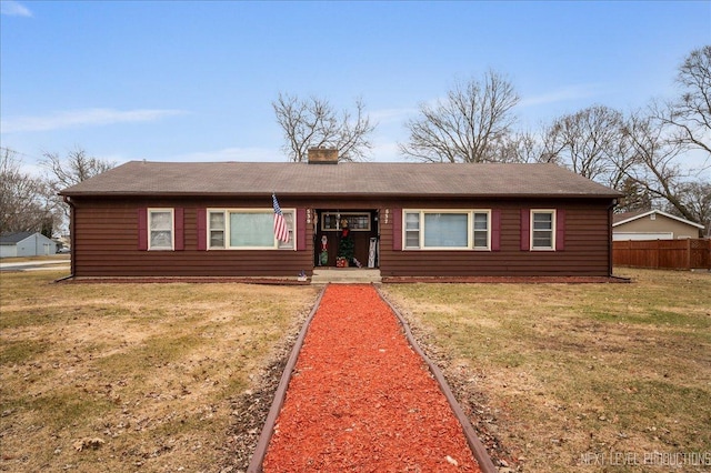 ranch-style home featuring a front yard