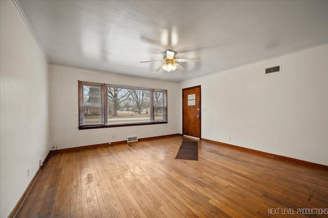 unfurnished room featuring hardwood / wood-style flooring, ornamental molding, and ceiling fan