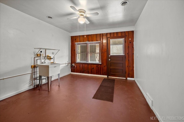 entrance foyer with wooden walls and ceiling fan