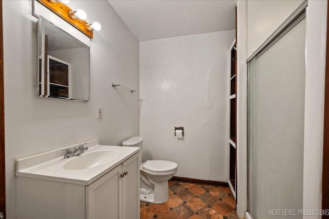 bathroom featuring walk in shower, vanity, and toilet