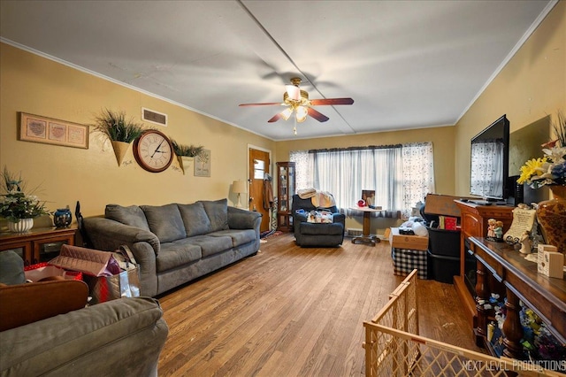 living room with ceiling fan, ornamental molding, and hardwood / wood-style floors