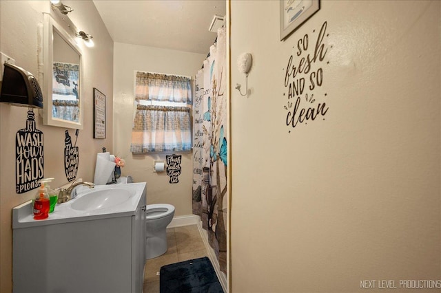 bathroom featuring vanity, tile patterned floors, and toilet