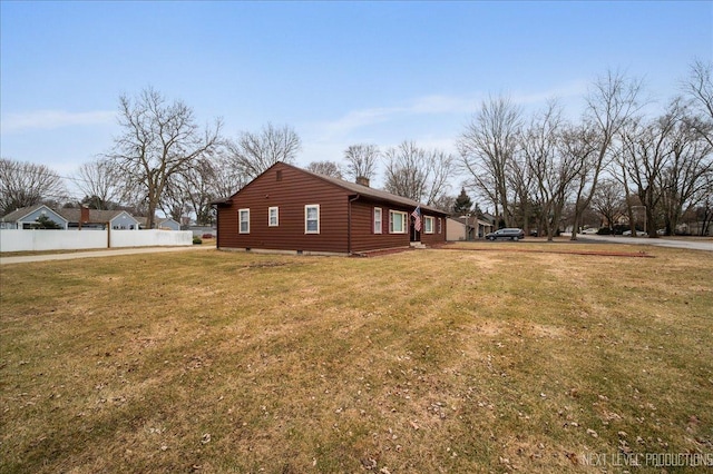 view of side of home featuring a yard