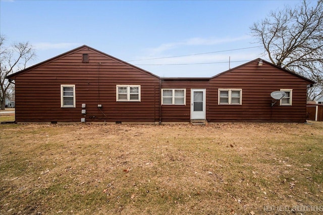 rear view of property with a lawn