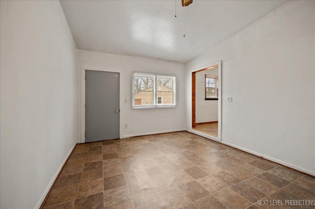 empty room featuring vaulted ceiling