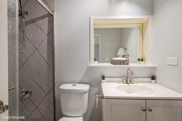 full bath featuring toilet, a shower stall, and vanity