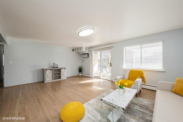 living room featuring a baseboard radiator and wood finished floors