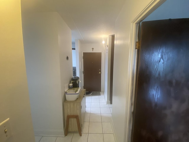 corridor with light tile patterned flooring