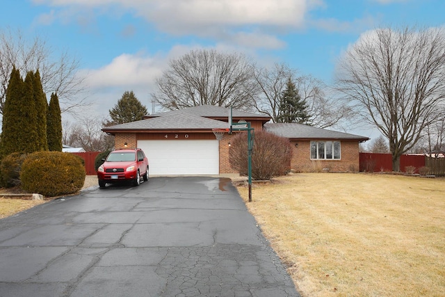 view of front of house with a garage and a front yard