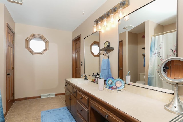 bathroom with vanity, tile patterned floors, and toilet