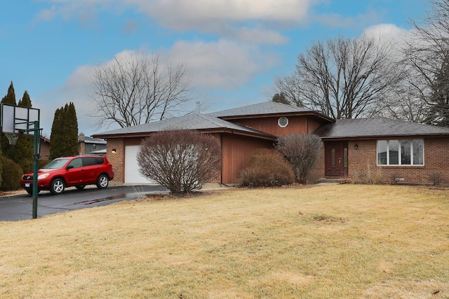 view of front of property featuring a garage and a front lawn