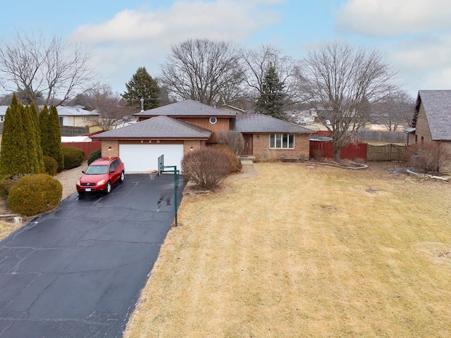 view of front of property featuring a garage and a front yard