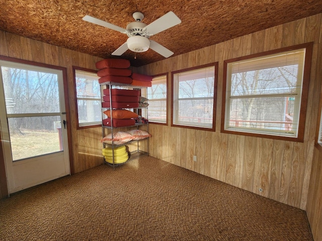 unfurnished sunroom with ceiling fan