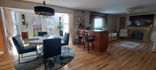 256 Homewood Dr, Bolingbrook, IL 60440 - dining room featuring light wood-type flooring and an inviting chandelier