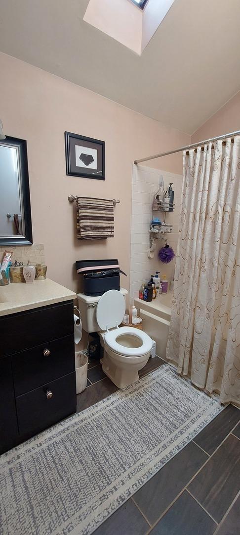 256 Homewood Dr, Bolingbrook, IL 60440 - full bathroom with tile patterned floors, toilet, shower / tub combo, and vanity