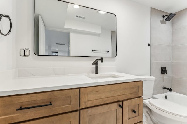 bathroom with visible vents, vanity, toilet, and tub / shower combination