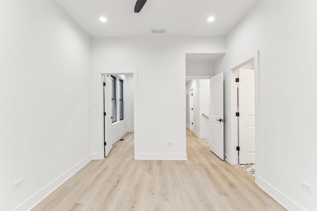 unfurnished room with light wood-style floors, visible vents, baseboards, and recessed lighting