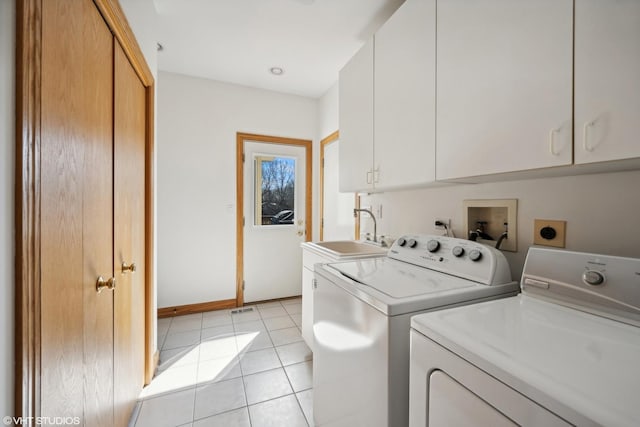 laundry room with cabinet space, light tile patterned flooring, a sink, separate washer and dryer, and baseboards