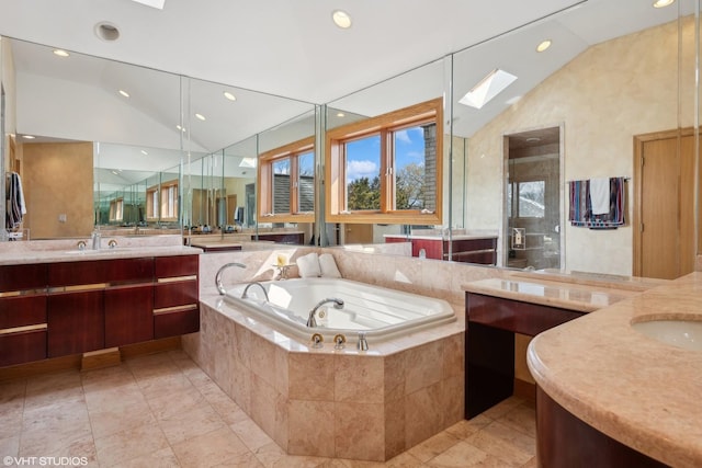 full bathroom featuring two vanities, a sink, vaulted ceiling, a bath, and a stall shower