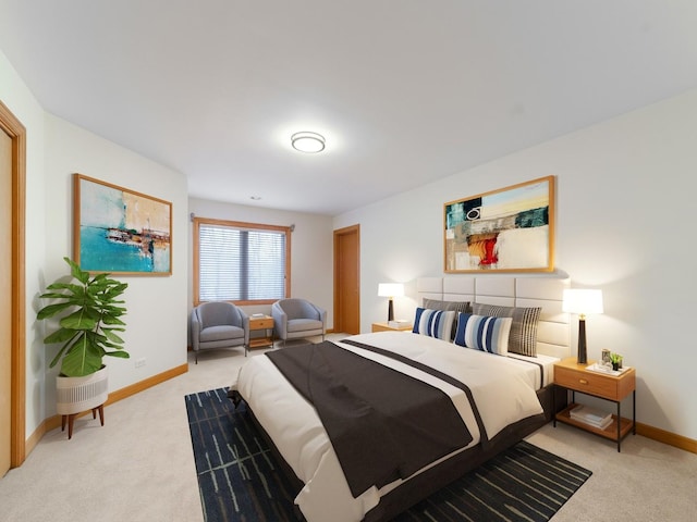 bedroom featuring light colored carpet and baseboards