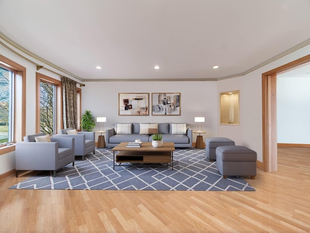 living room featuring baseboards, ornamental molding, wood finished floors, and recessed lighting