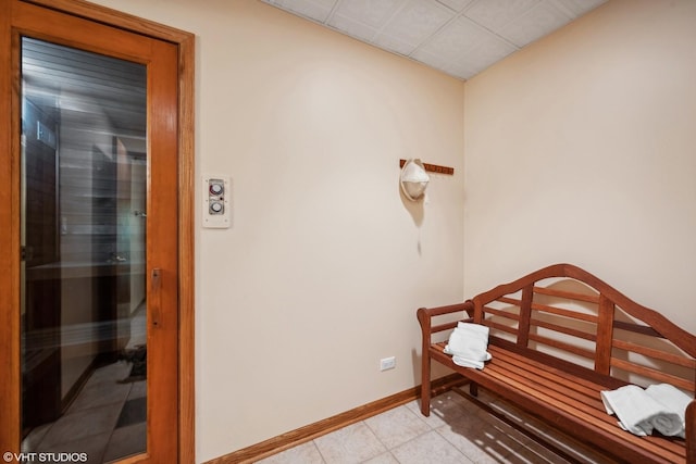 interior space featuring a sauna, baseboards, and light tile patterned flooring