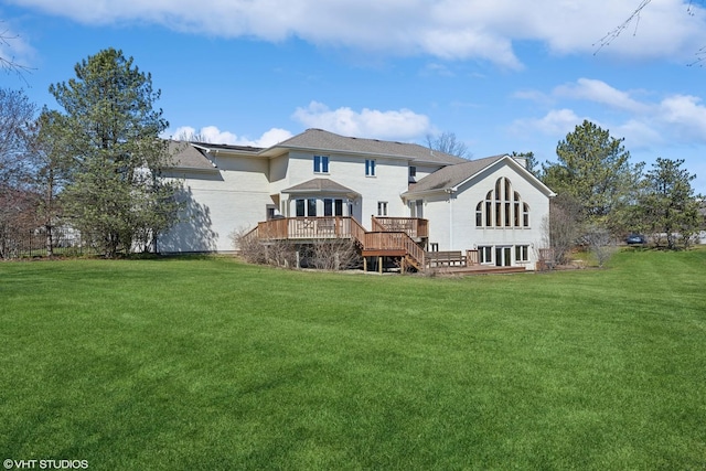 rear view of property featuring a deck and a yard