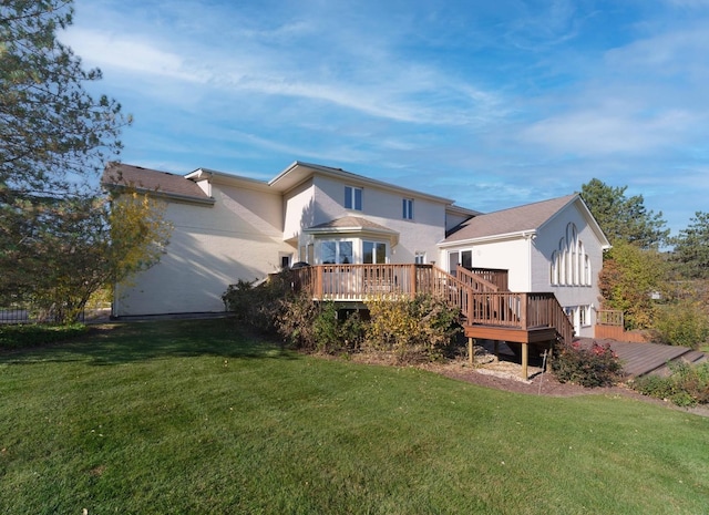 back of house featuring a deck and a yard