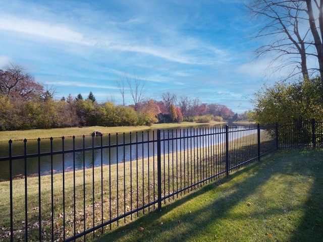 view of yard with a water view and fence