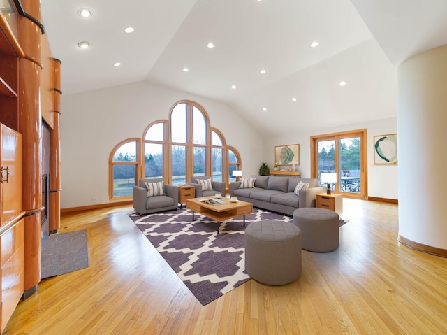 living room featuring high vaulted ceiling, recessed lighting, light wood-type flooring, and baseboards