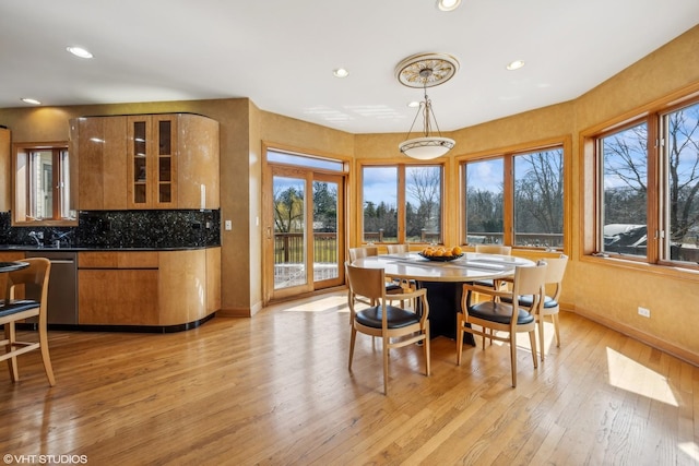 dining area featuring light wood-type flooring, baseboards, and recessed lighting