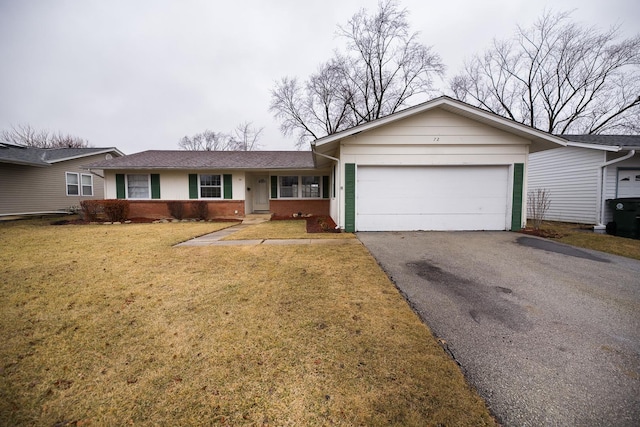 ranch-style home with driveway, brick siding, a front lawn, and an attached garage