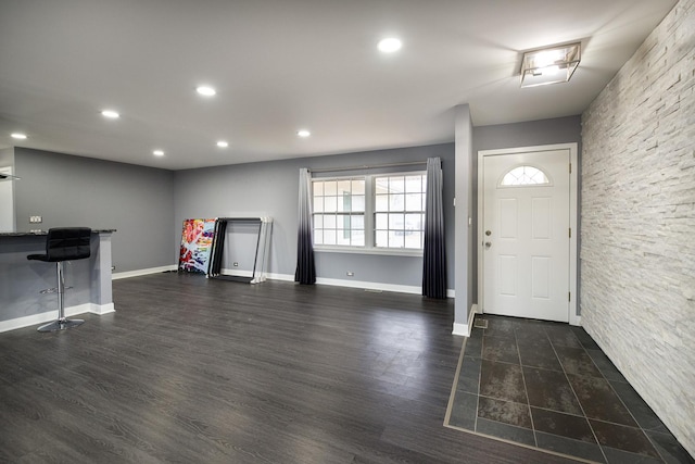 entrance foyer featuring dark wood-type flooring, recessed lighting, and baseboards