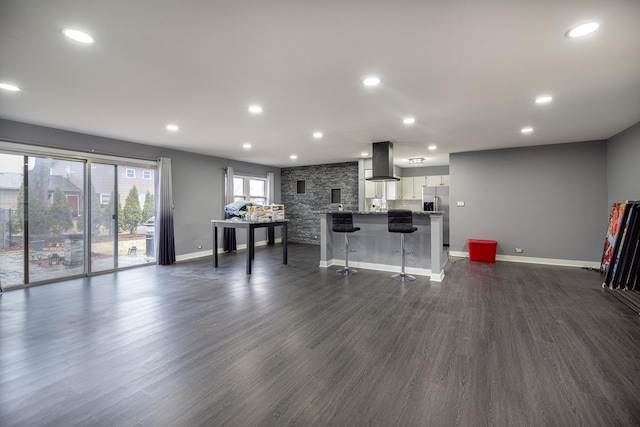 interior space with baseboards, dark wood-type flooring, and recessed lighting