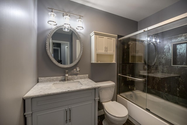 full bath with toilet, vanity, and enclosed tub / shower combo