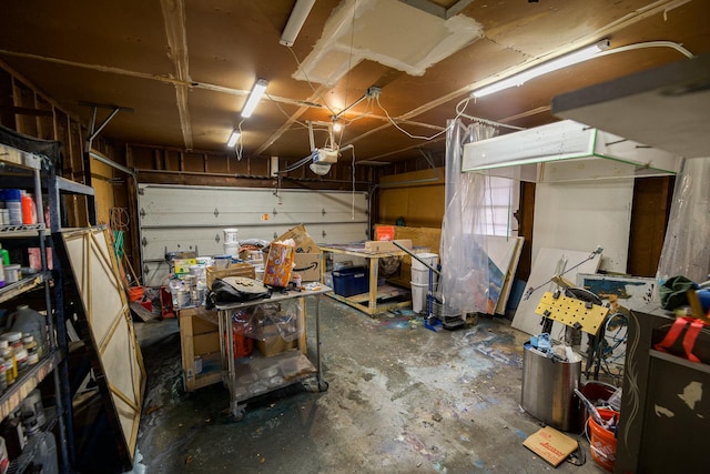 garage with a workshop area and a garage door opener