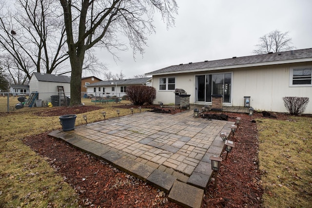 back of property featuring a patio area and fence