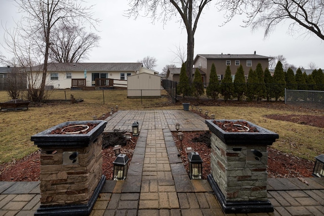 view of patio / terrace with a garden, a fenced backyard, and a fire pit