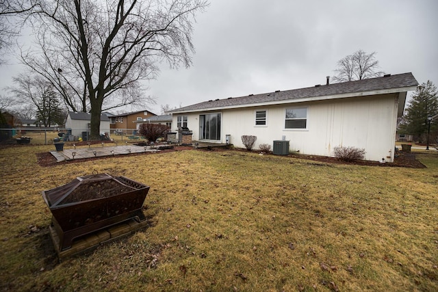 back of house with a lawn, fence, and central air condition unit