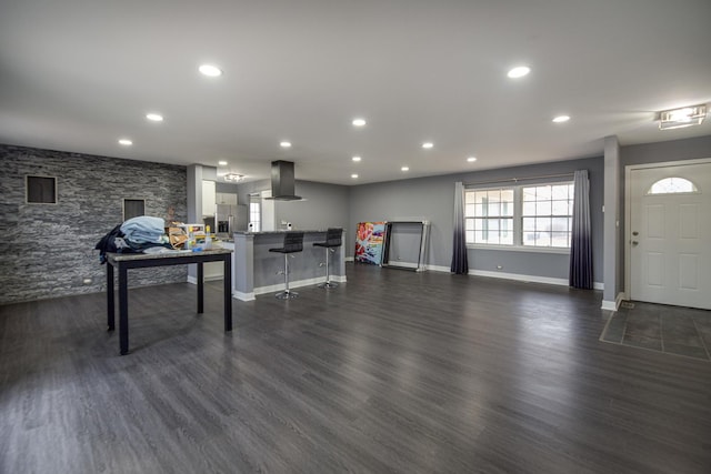 living area with baseboards, dark wood finished floors, and recessed lighting