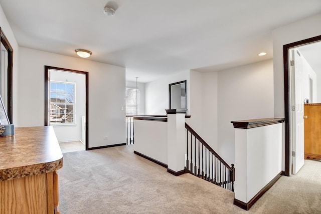 hall featuring light colored carpet