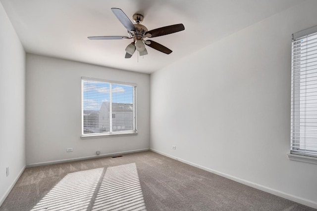 empty room with ceiling fan and light colored carpet